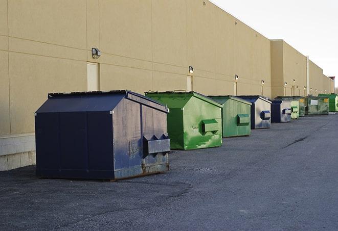 a row of blue construction dumpsters on a job site in Country Club Hills